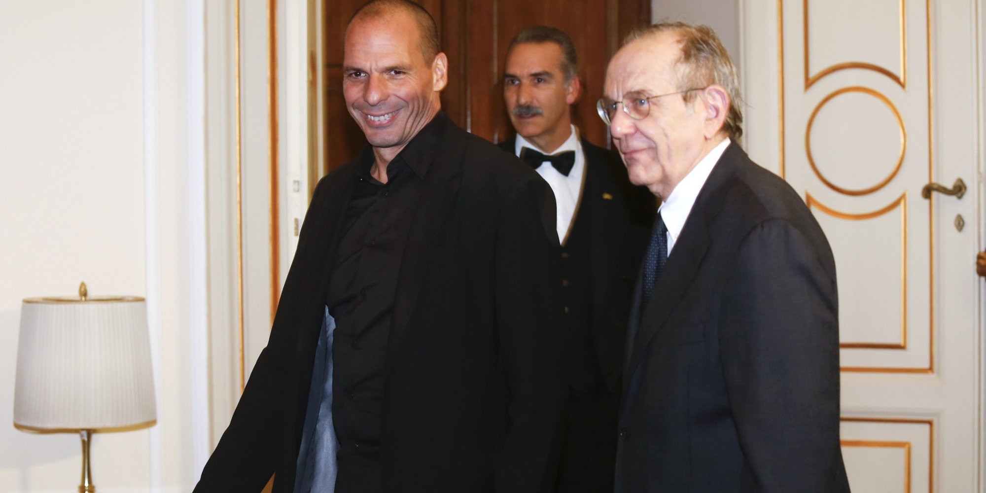 Greek Finance Minister Varoufakis walks next his Italian counterpart Pier Carlo Padoan during a meeting in Rome
